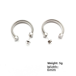 Detail of silver C-shaped industrial earring, 6mm wide, 5g, with spring texture design