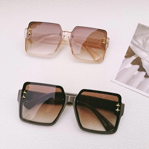 Fashion oversized square sunglasses with star metal accents in black and champagne colors