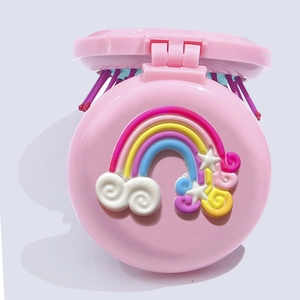 Detailed close-up of a pink portable folding mirror brush with 3D rainbow and star decor