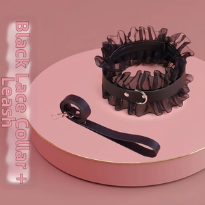 Detailed shot of black lace choker and matching leash on a pink display stand