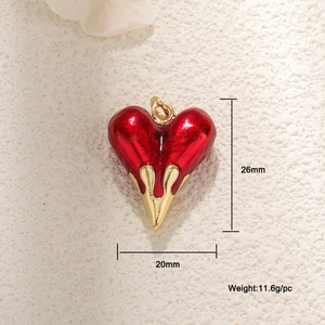 Detail view of a 26mm red enamel heart pendant with gold dripping edge and dimensions