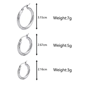 Three pairs of vintage gold twill stainless steel hoop earrings in varying sizes