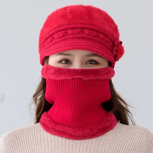 Detail of red winter knit hat and neck warmer set with faux fur lining and floral decor