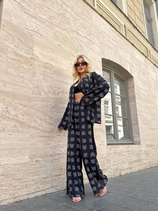 Women's black two-piece set with white geometric cat print featuring long sleeve shirt and pants