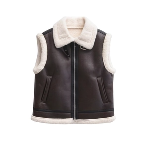 Detail of dark brown faux leather vest featuring soft cream faux fur lining and zipper