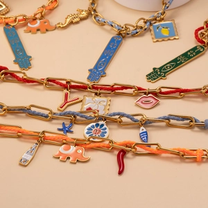 Colorful woven rope necklace with Fatima hand and elephant charms on gold metal chain