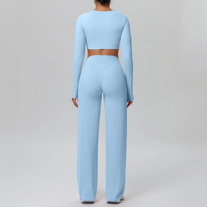 Back view of light blue yoga set featuring long sleeve crop top and wide leg pants