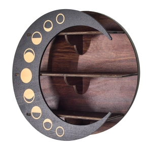 Detail of round wooden moon shelf featuring crescent moon and phases cutout designs