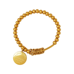 Gold beaded bracelet with round pendant engraved with Fantastic New York text