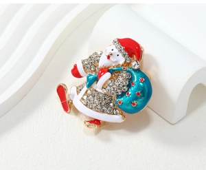 Close-up of Santa Claus enamel brooch with glittering crystals and golden base finish