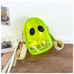 Detail of neon yellow ghost-shaped transparent jelly bag with wide wavy strap and gold hardware