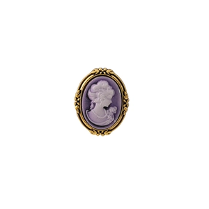 Close-up of lilac relief cameo brooch featuring vintage golden ornate floral frame