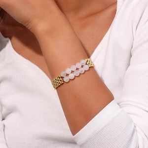 Detail of pink quartz beads combined with a polished golden watchband chain bracelet