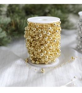 Detail of 10m gold bead chain on spool for Christmas tree and window decoration