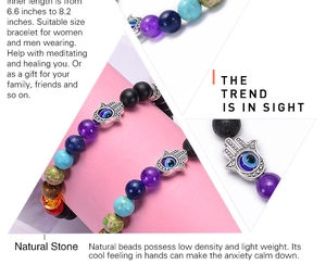 Detail view of colorful natural stone beads and Hamsa hand evil eye charm on bracelet