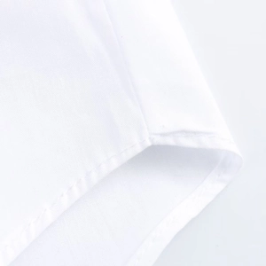 Detailed macro view of white shirt fabric texture and professional bottom hem stitching