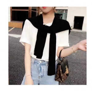 Knitted core-spun yarn shawl scarf draped over a casual white cotton T-shirt