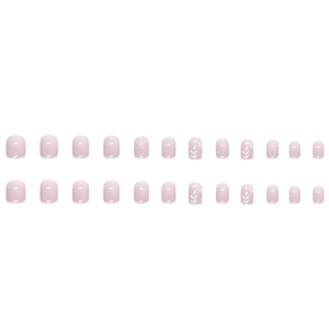 Short oval French tip press-on nails in nude pink with white leaf patterns and glitter