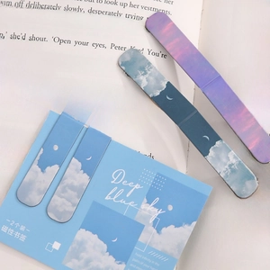 Deep blue sky magnetic bookmarks with clouds and moon on an open vintage book page