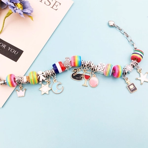 Detailed view of beaded charm bracelet with rainbow striped resin beads and mixed alloy pendants