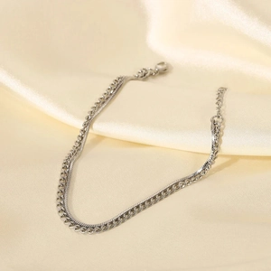 Silver double-layered Cuban and snake chain men's bracelet on beige silk fabric