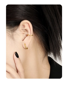Detail shot of golden geometric S925 sterling silver hoop earrings with hammered texture