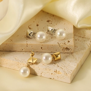 Elegant 18K gold plated stainless steel geometric pearl earrings on silk background