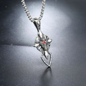Silver stainless steel cross pendant necklace with wings and a sparkling red gemstone