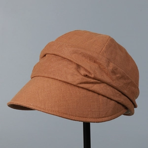 Detail showing natural pleated texture of breathable linen sun hat in caramel brown