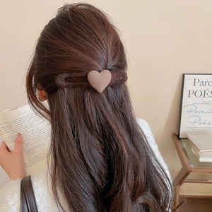 Close-up of deep brown plush heart hair clip showing soft faux fur texture and warmth