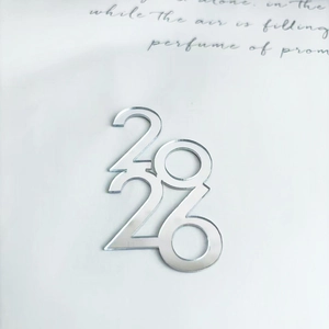 Macro shot of mirror silver acrylic 2026 cupcake topper with elegant text background