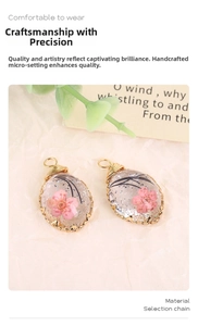 Macro detail of oval resin pendant with pink petals and gold wire wrapping
