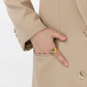 Fashionable 18K gold stainless steel heart ring shown on model's hand with chic styling