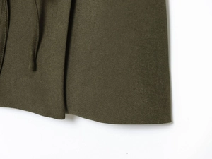 Detailed close-up of army green twill fabric texture and professional hem stitching