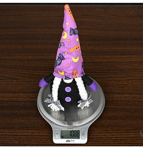 Detail showing Halloween purple gnome on electronic scale for weight measurement