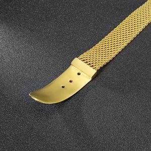 Detailed macro view of gold-plated stainless steel mesh bracelet with adjustment holes