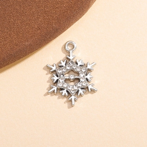 Macro shot of silver snowflake pendant charm with sparkling rhinestones and a top loop