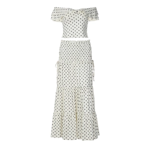 Detailed view of polka dot off-shoulder crop top and matching tiered maxi skirt set