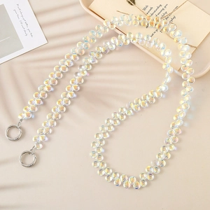 Crossbody iridescent beaded phone lanyard with silver metal rings on a soft beige background