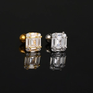 Macro shot of gold and silver square zircon stud earrings with polished screw backs