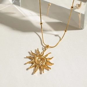 Golden stainless steel sun pendant necklace with hammered spiral design and beaded chain