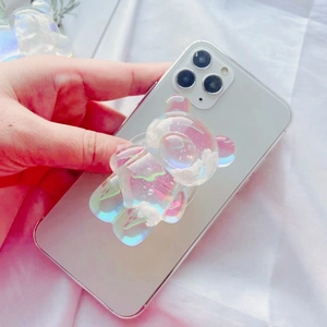 Close-up of a 3D colorful iridescent bear phone socket with white cloud motif