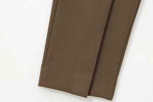 Dettaglio dei pantaloni balloon marrone caffè con tessuto in twill denso e cuciture pulite