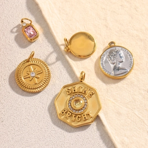 Macro view of 18K gold and silver plated coin pendants with star and queen details
