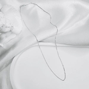 Detailed view of silver S925 sterling silver O-chain on elegant white silk fabric