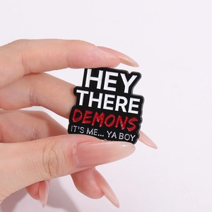 Minimalist black enamel badge pin with HEY THERE DEMONS letter design for clothing decoration