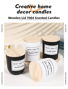 Close-up of matte glass aromatherapy candle with natural wood lid and elegant label