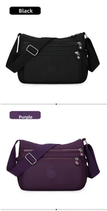 Front view of black and purple waterproof nylon shoulder bags with multi-zipper pockets