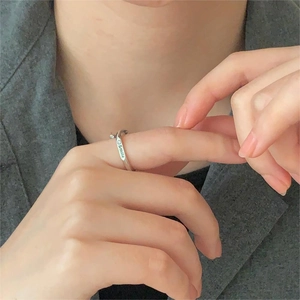 Close-up of silver smile engraved ring on finger with professional minimalist style