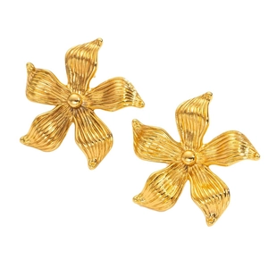 Brushed gold flower earrings with central pearl on a clean white background